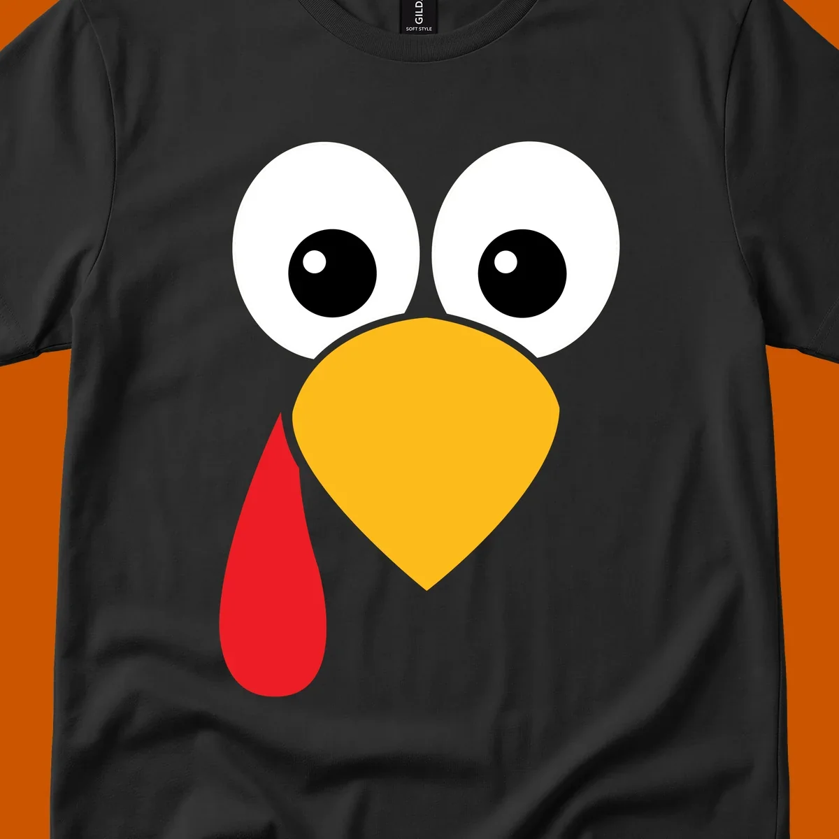 Funny turkey face illustration with big eyes, yellow beak, and red wattle for Thanksgiving.