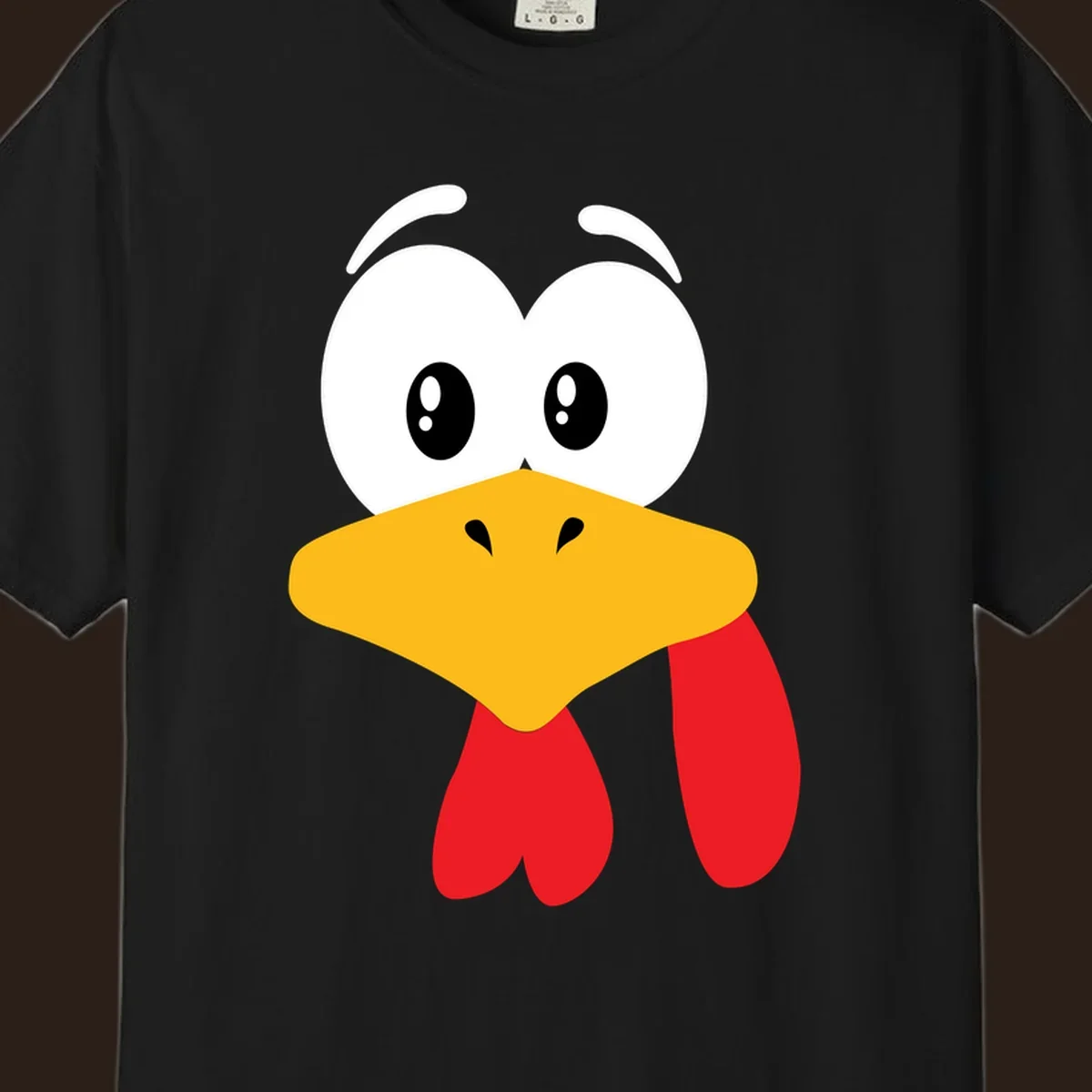 Funny cartoon turkey face graphic with googly eyes and a yellow beak.