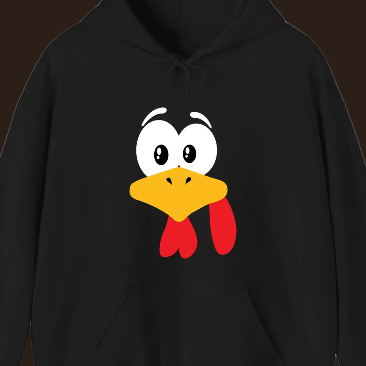 Funny cartoon turkey face graphic with googly eyes and a yellow beak.