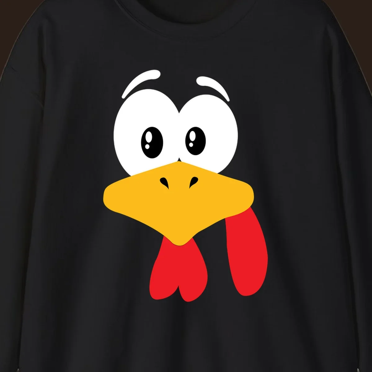 Funny cartoon turkey face graphic with googly eyes and a yellow beak.