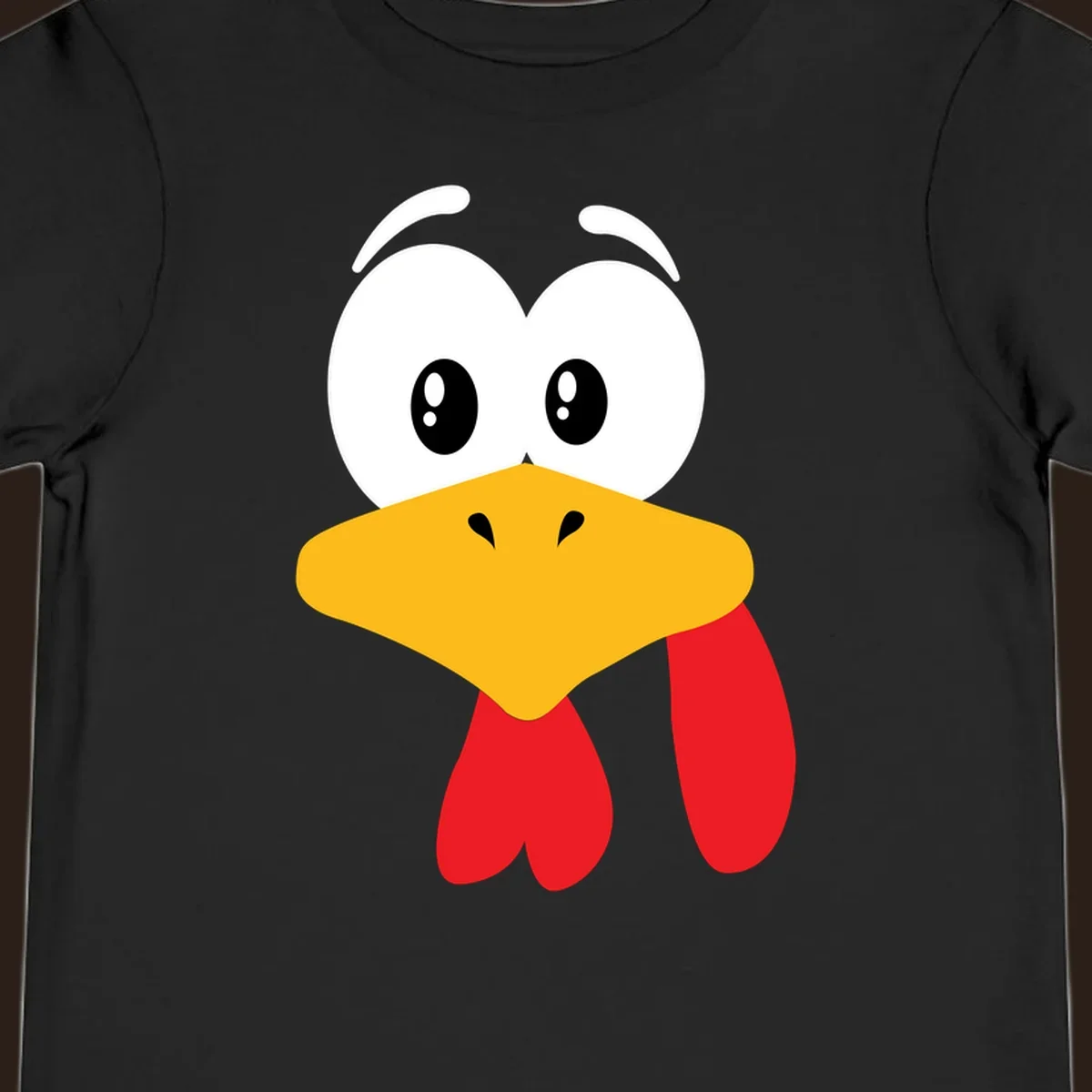 Funny cartoon turkey face graphic with googly eyes and a yellow beak.