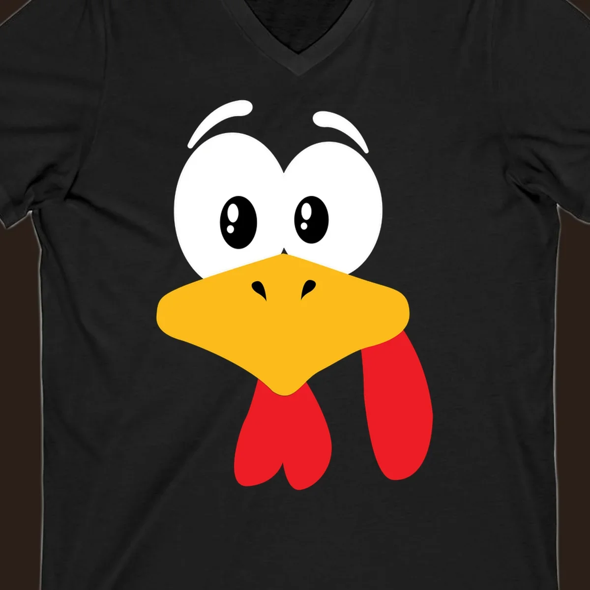 Funny cartoon turkey face graphic with googly eyes and a yellow beak.
