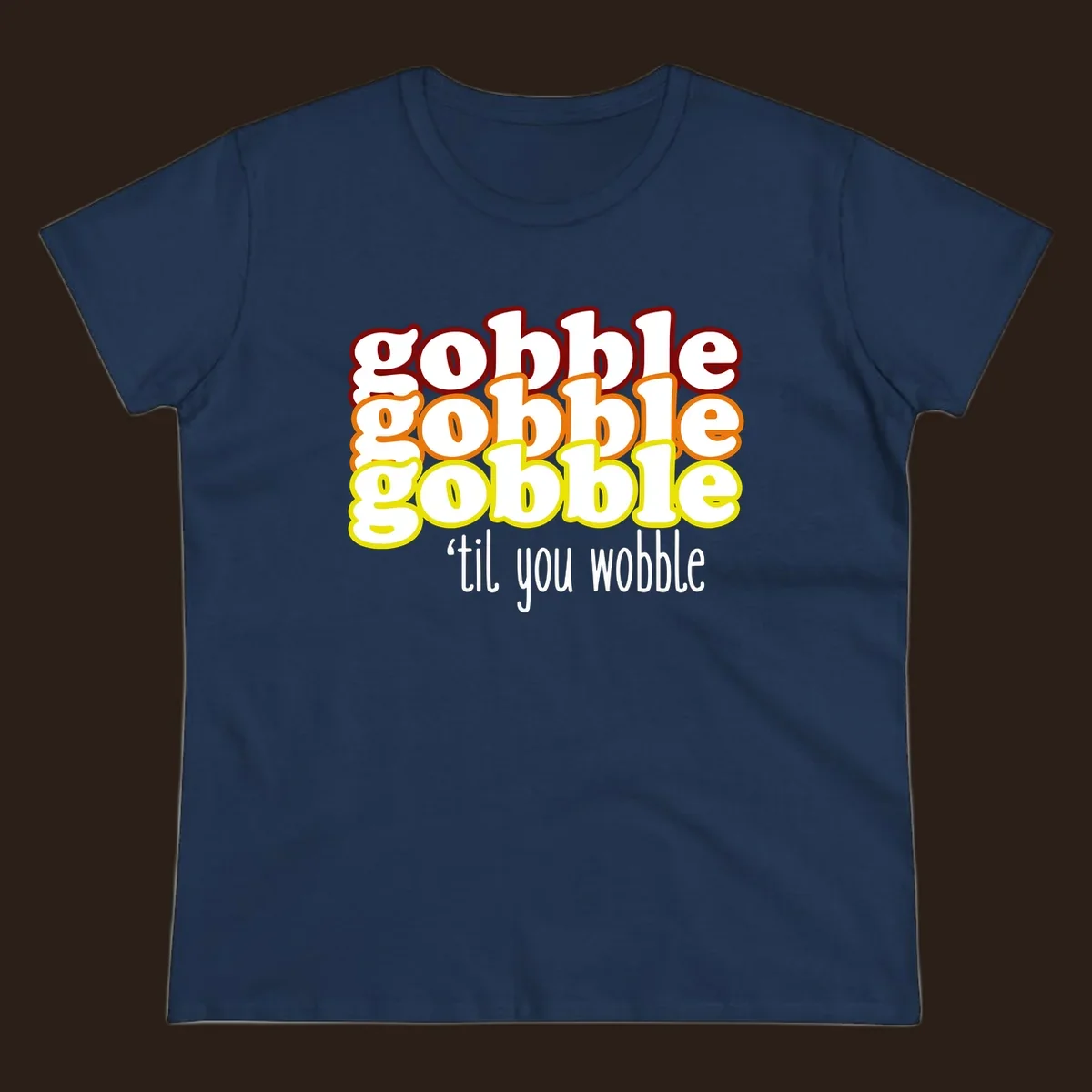 Gobble 'til you wobble thanksgiving text design with stacked gobble words in red, orange, yellow and white text below.