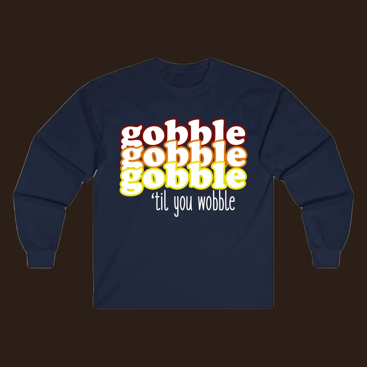 Gobble 'til you wobble thanksgiving text design with stacked gobble words in red, orange, yellow and white text below.