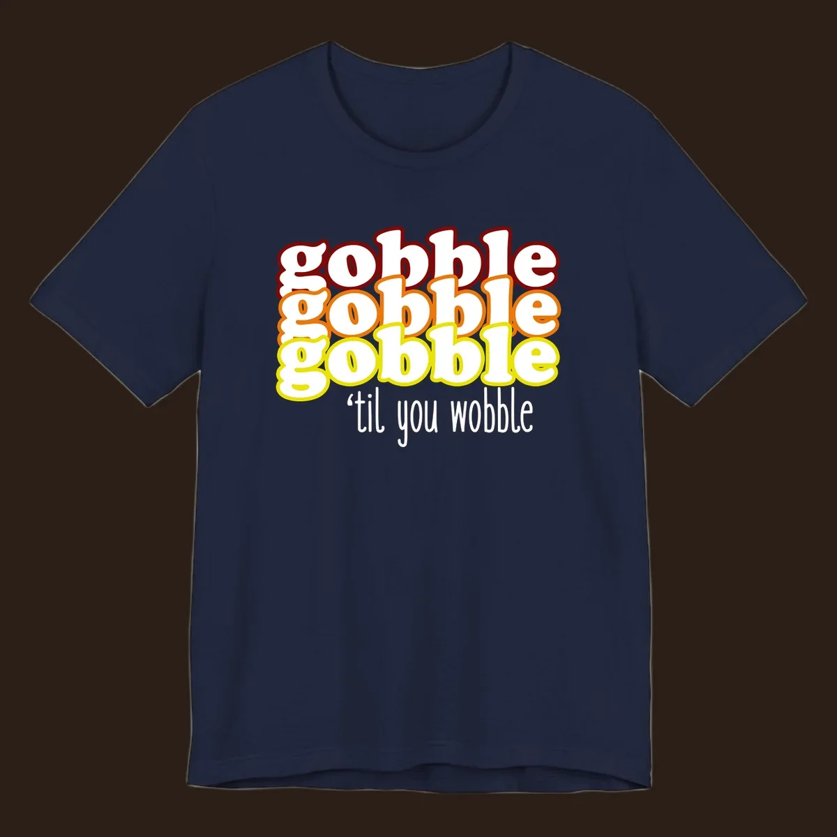 Gobble 'til you wobble thanksgiving text design with stacked gobble words in red, orange, yellow and white text below.