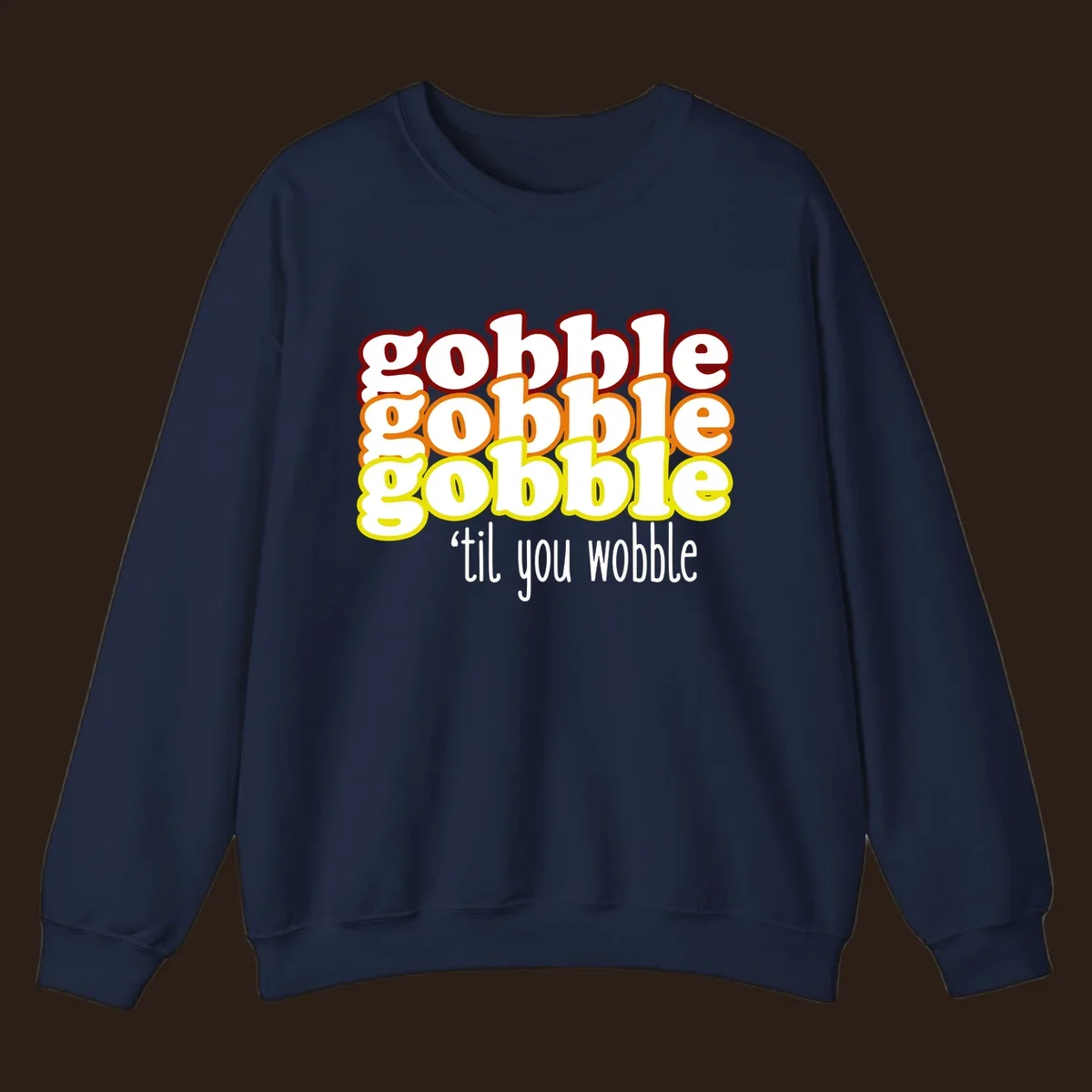 Gobble 'til you wobble thanksgiving text design with stacked gobble words in red, orange, yellow and white text below.