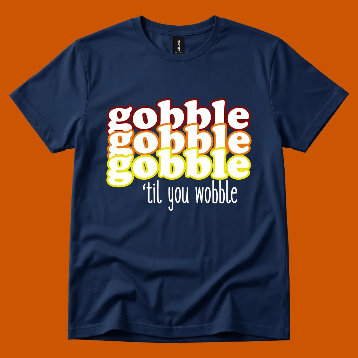 Gobble 'til you wobble thanksgiving text design with stacked gobble words in red, orange, yellow and white text below.