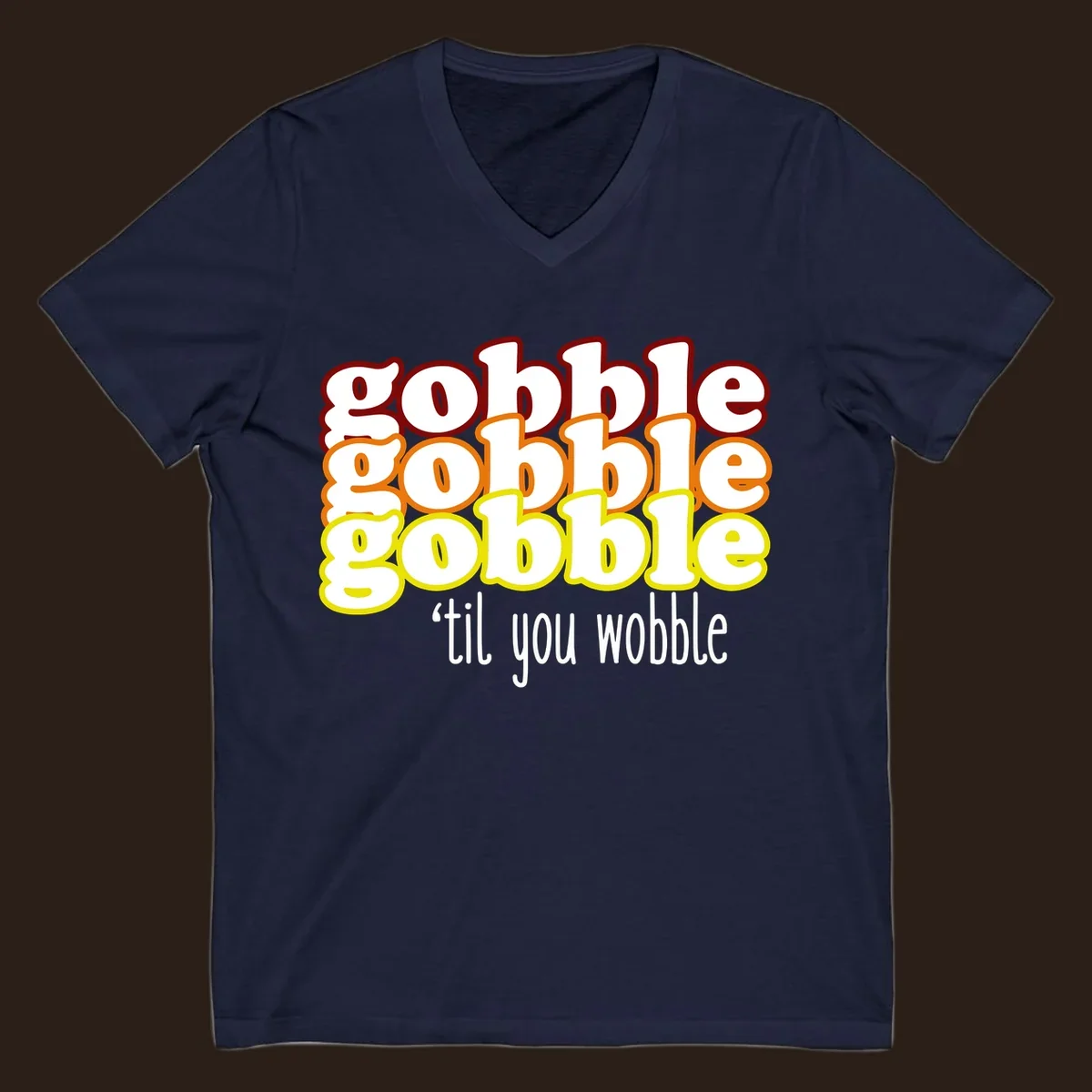 Gobble 'til you wobble thanksgiving text design with stacked gobble words in red, orange, yellow and white text below.
