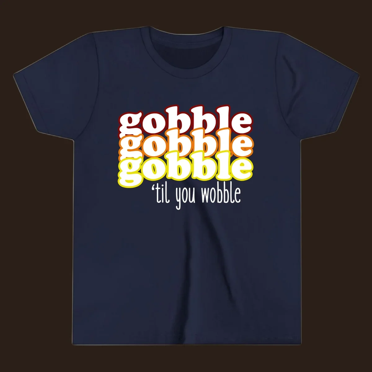 Gobble 'til you wobble thanksgiving text design with stacked gobble words in red, orange, yellow and white text below.