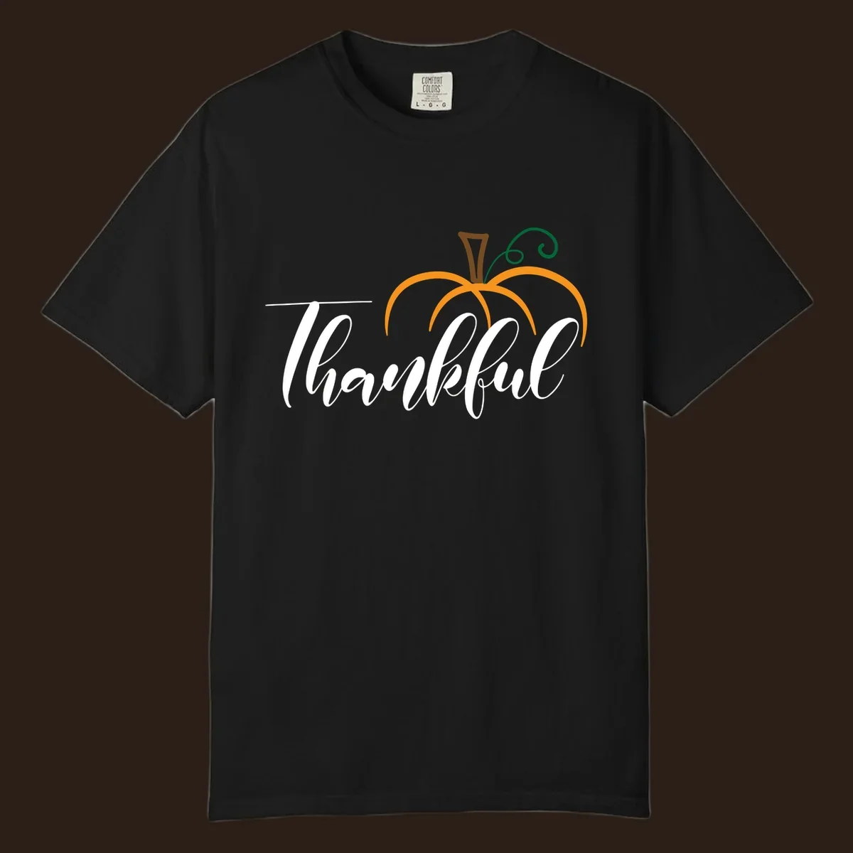 White script text 'Thankful' with a stylized orange pumpkin illustration.