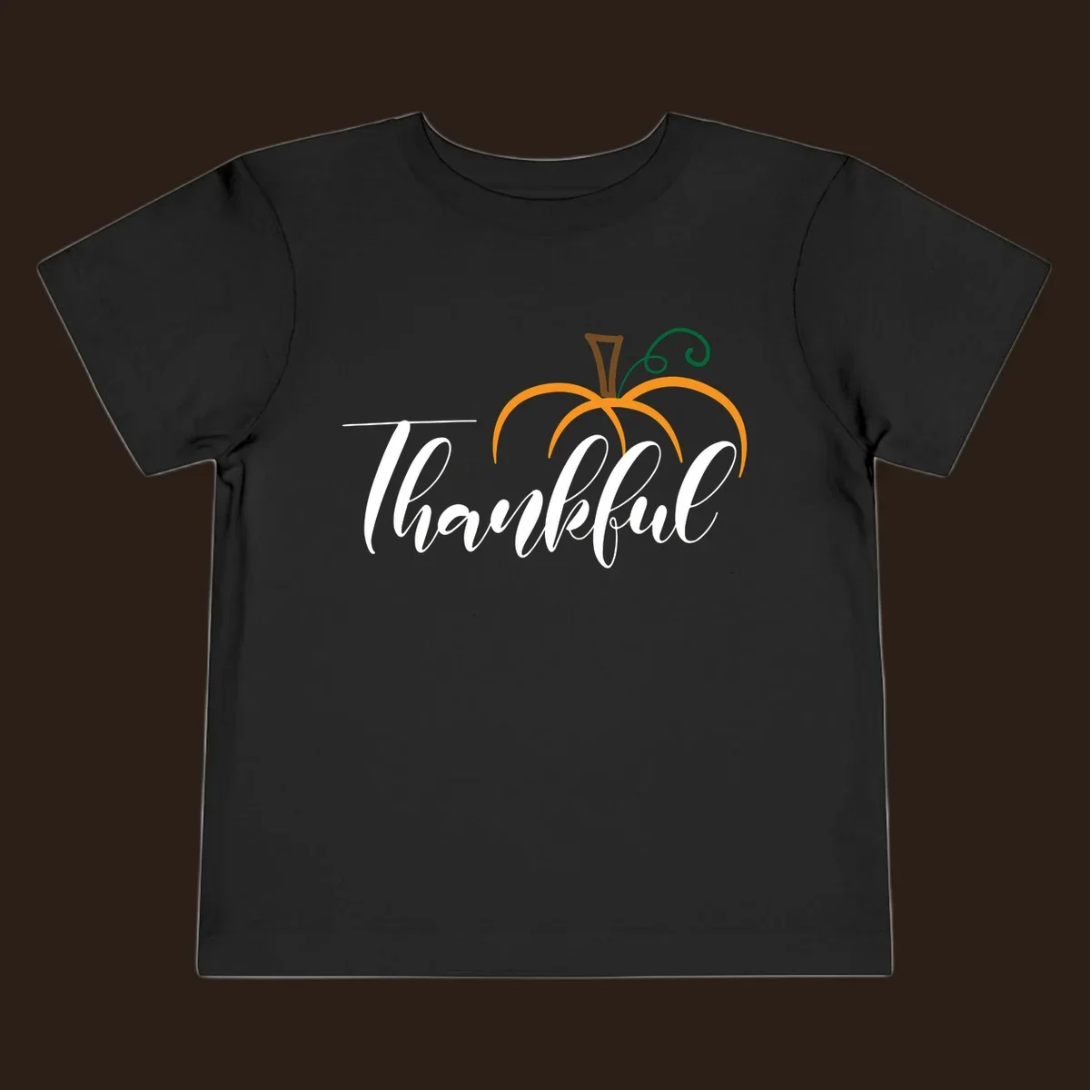White script text 'Thankful' with a stylized orange pumpkin illustration.