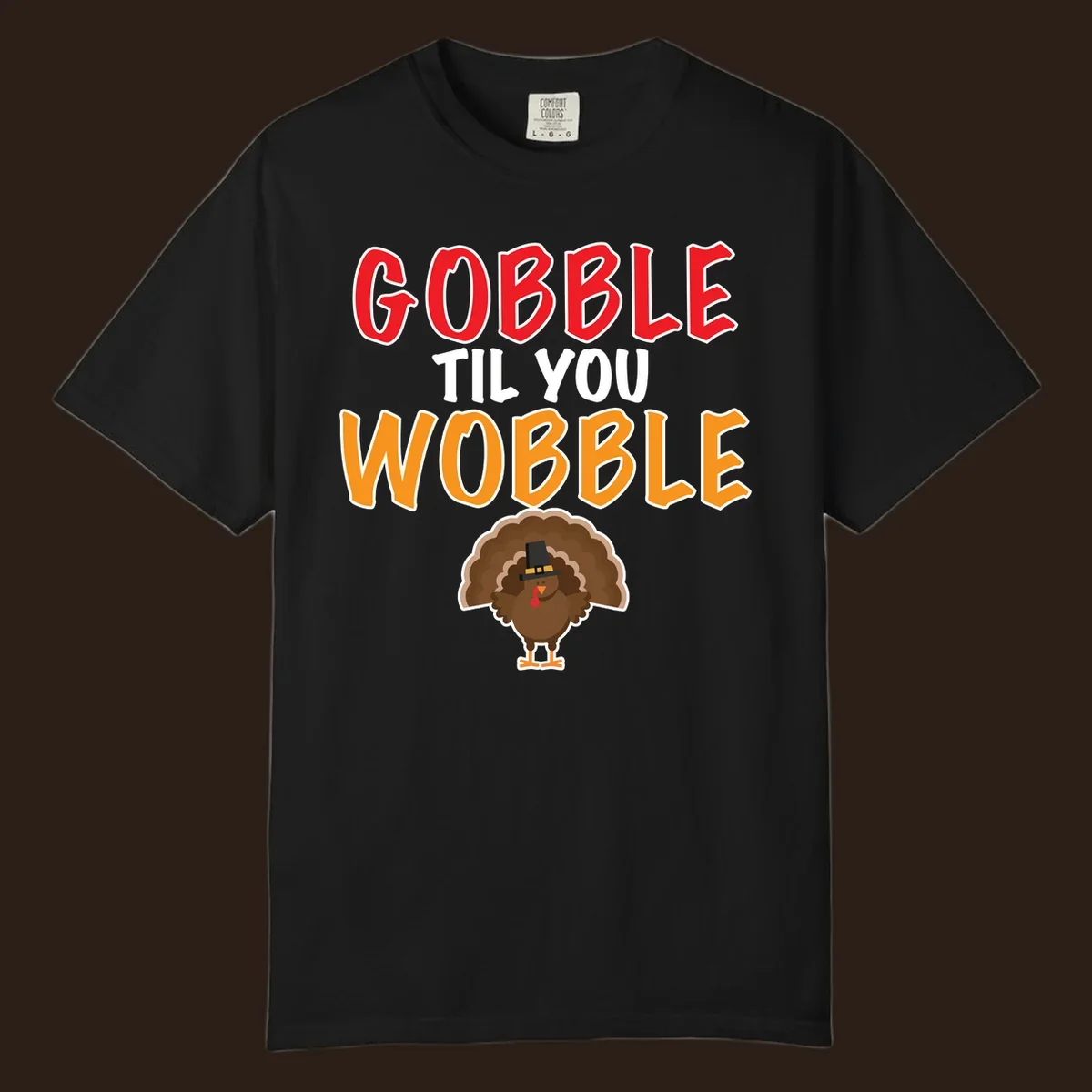 Gobble Til You Wobble text with a cartoon turkey wearing a pilgrim hat.