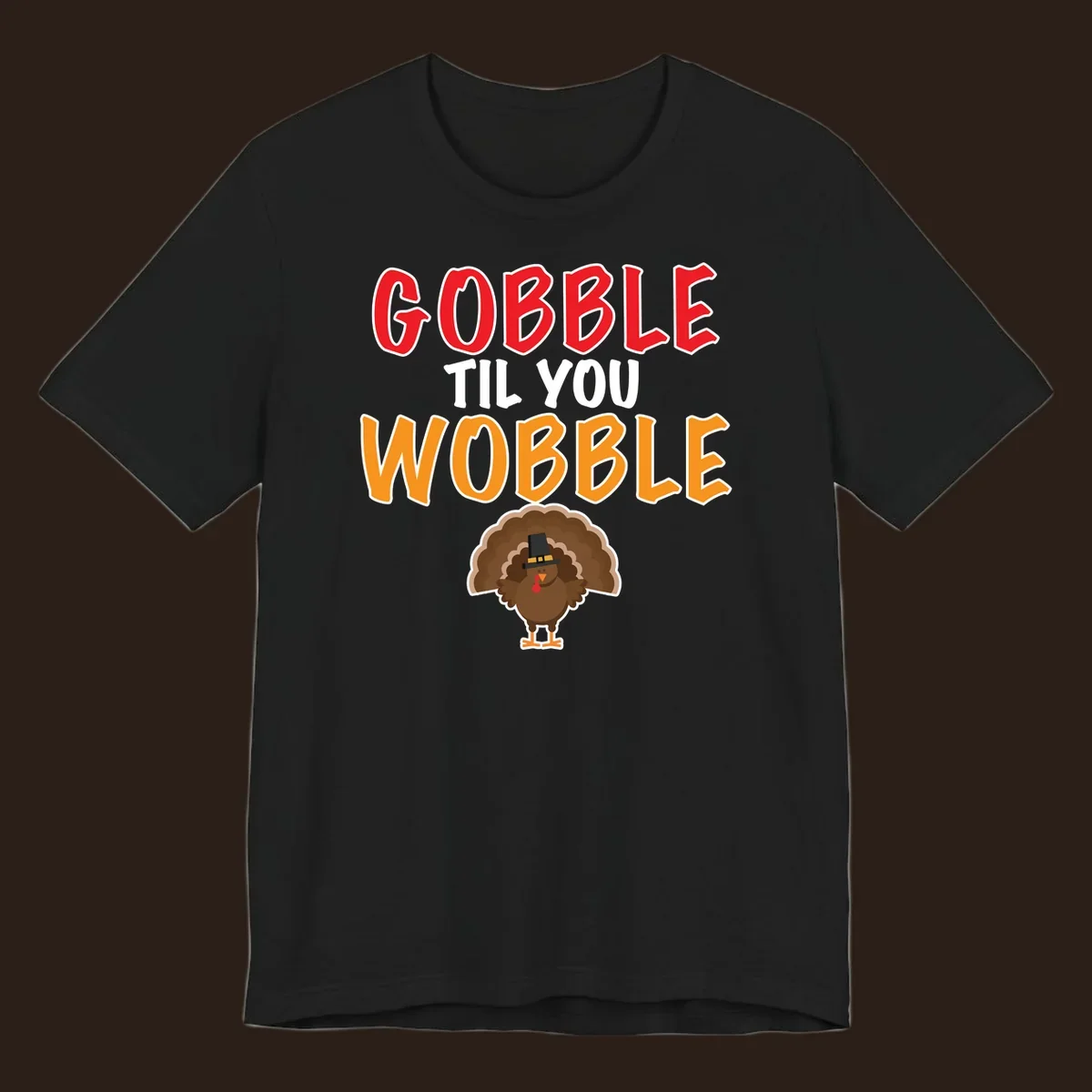 Gobble Til You Wobble text with a cartoon turkey wearing a pilgrim hat.
