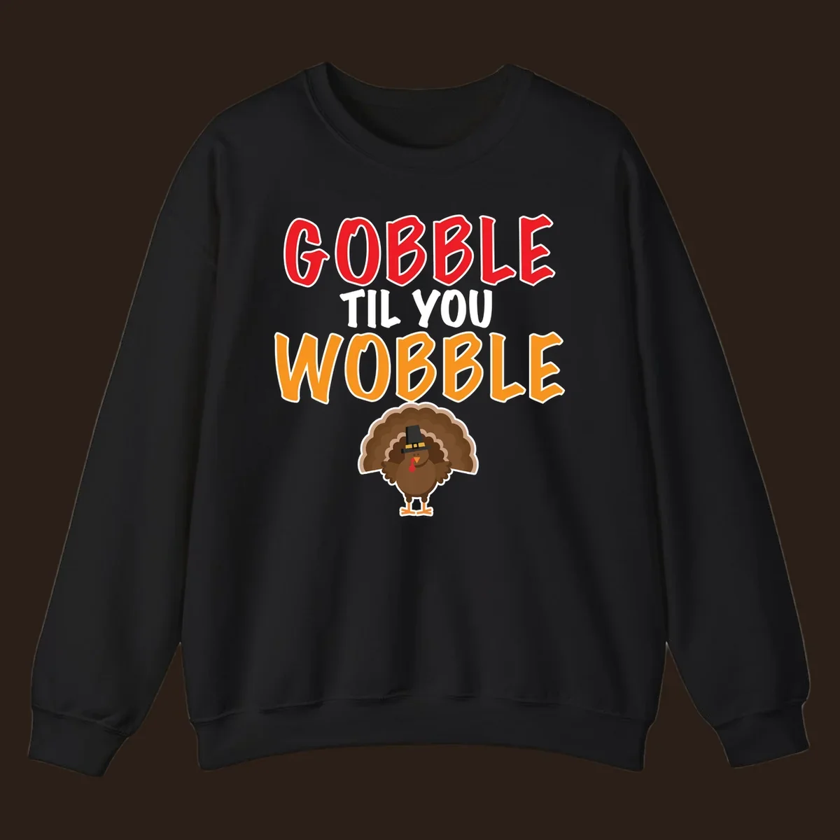 Gobble Til You Wobble text with a cartoon turkey wearing a pilgrim hat.