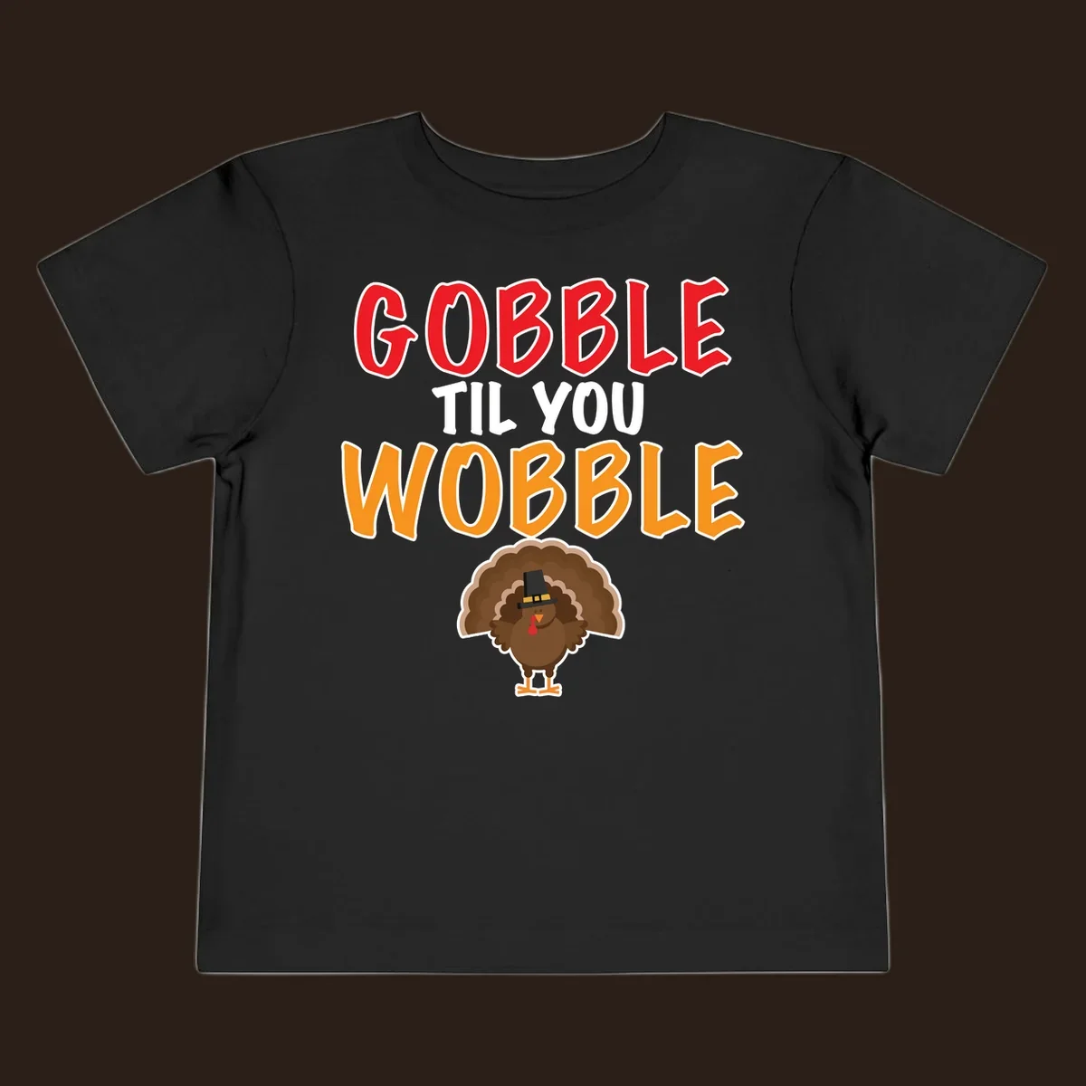Gobble Til You Wobble text with a cartoon turkey wearing a pilgrim hat.