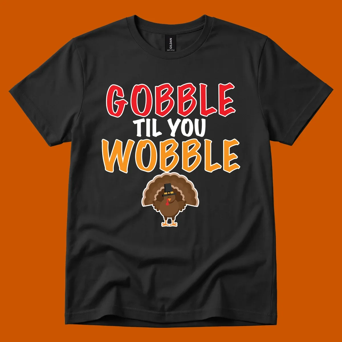Gobble Til You Wobble text with a cartoon turkey wearing a pilgrim hat.