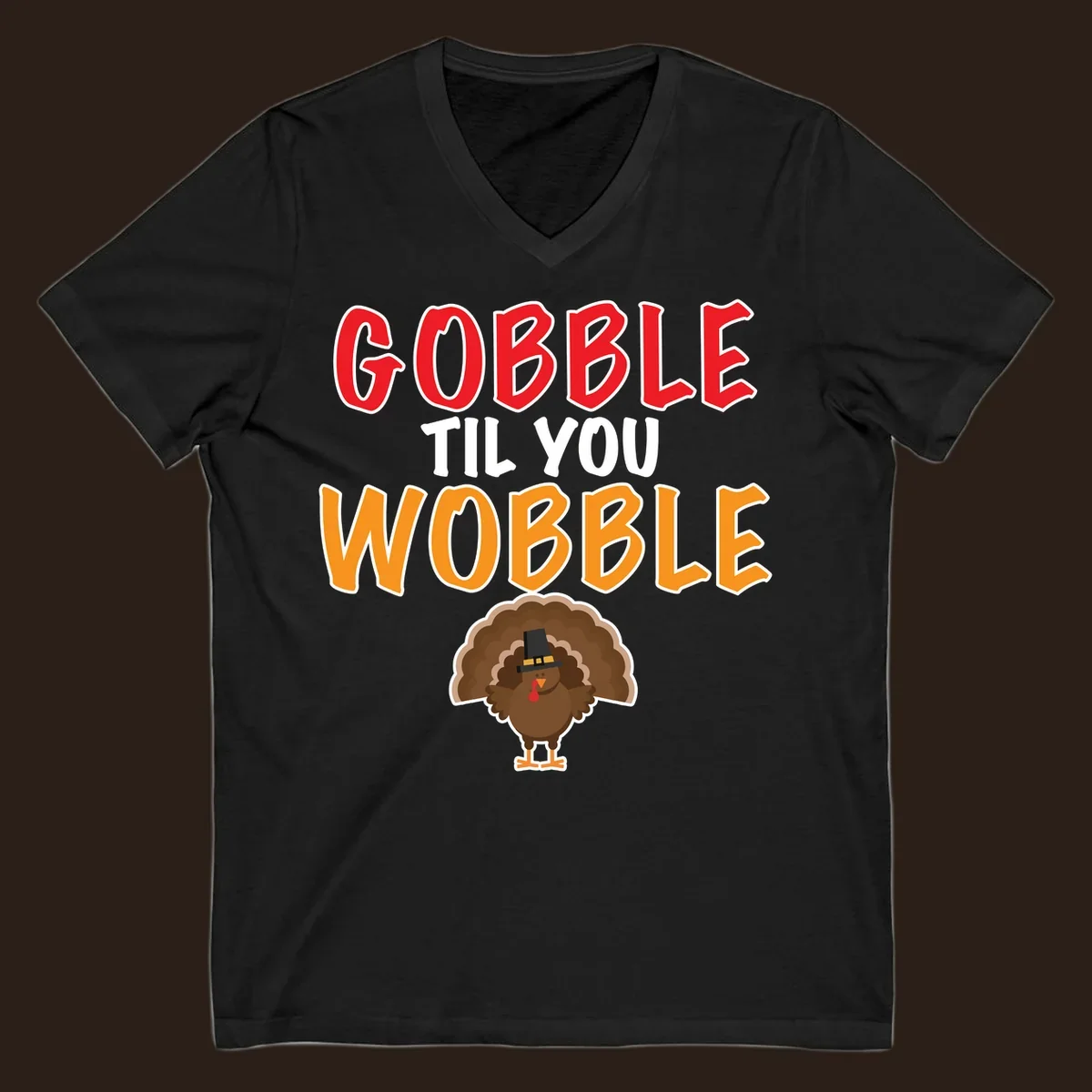 Gobble Til You Wobble text with a cartoon turkey wearing a pilgrim hat.