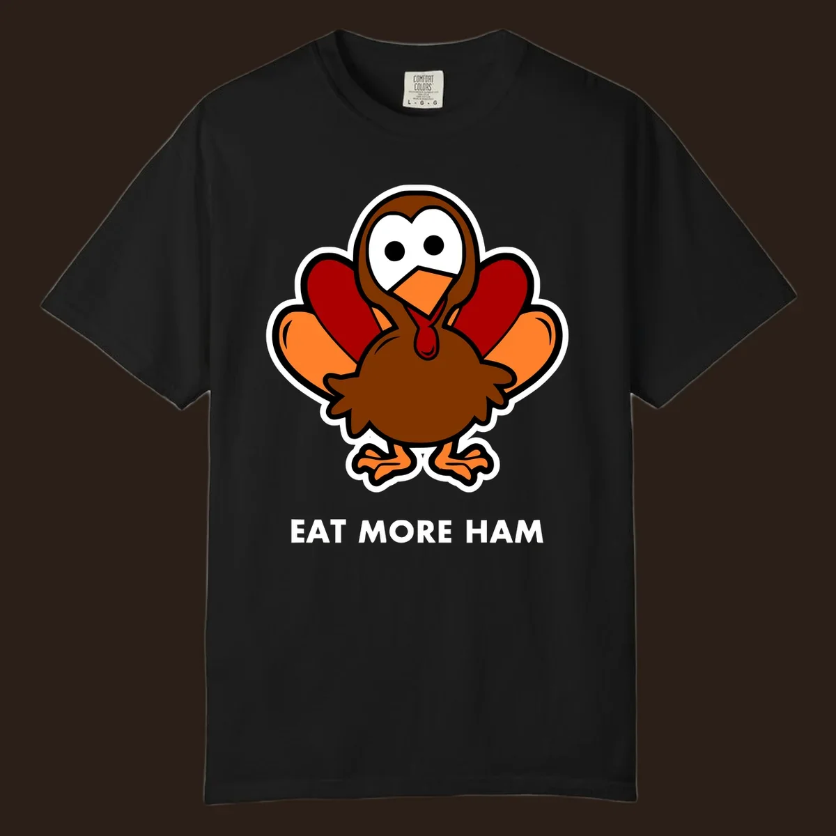 Cartoon turkey with 'Eat More Ham' text, promoting a fun Thanksgiving alternative.