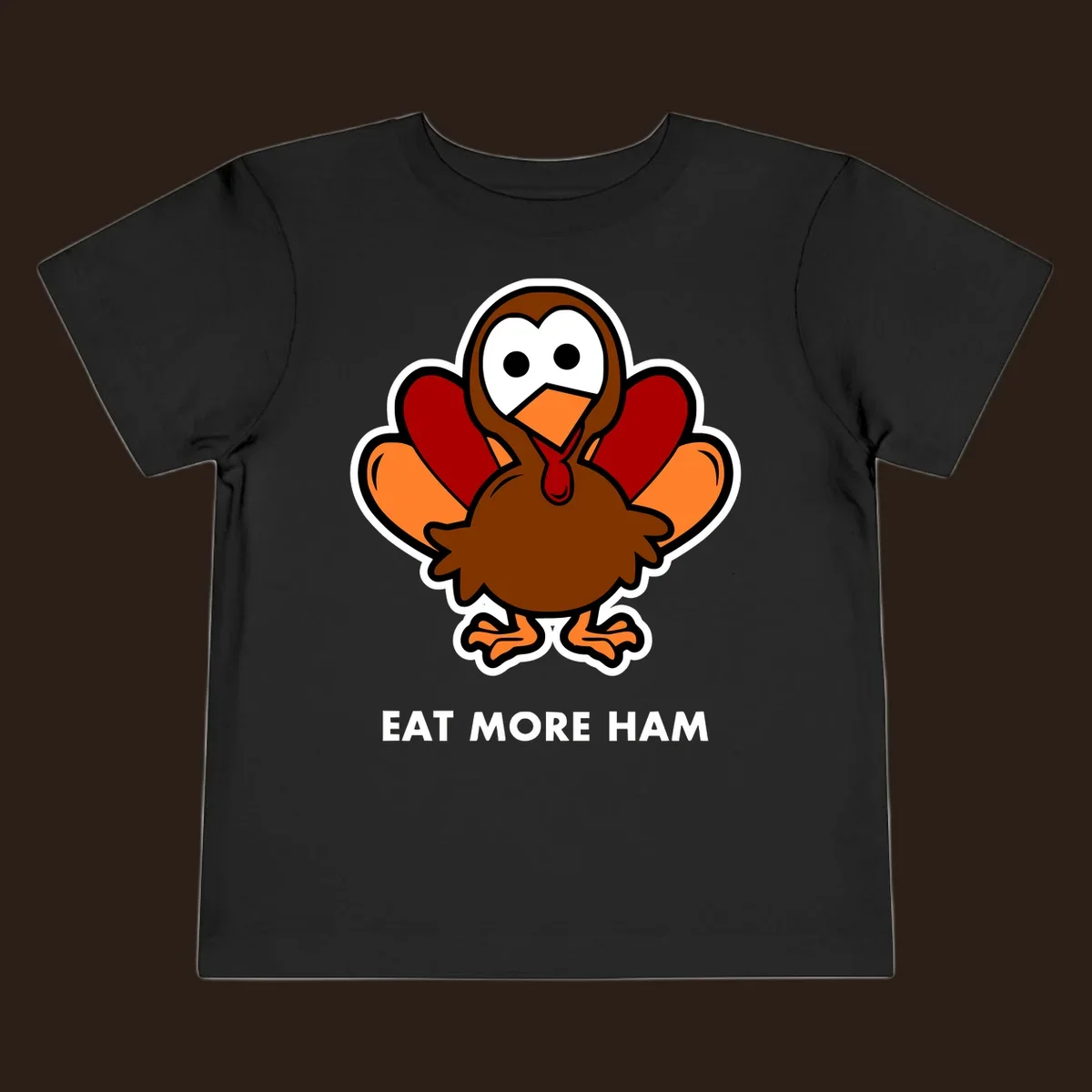 Cartoon turkey with 'Eat More Ham' text, promoting a fun Thanksgiving alternative.