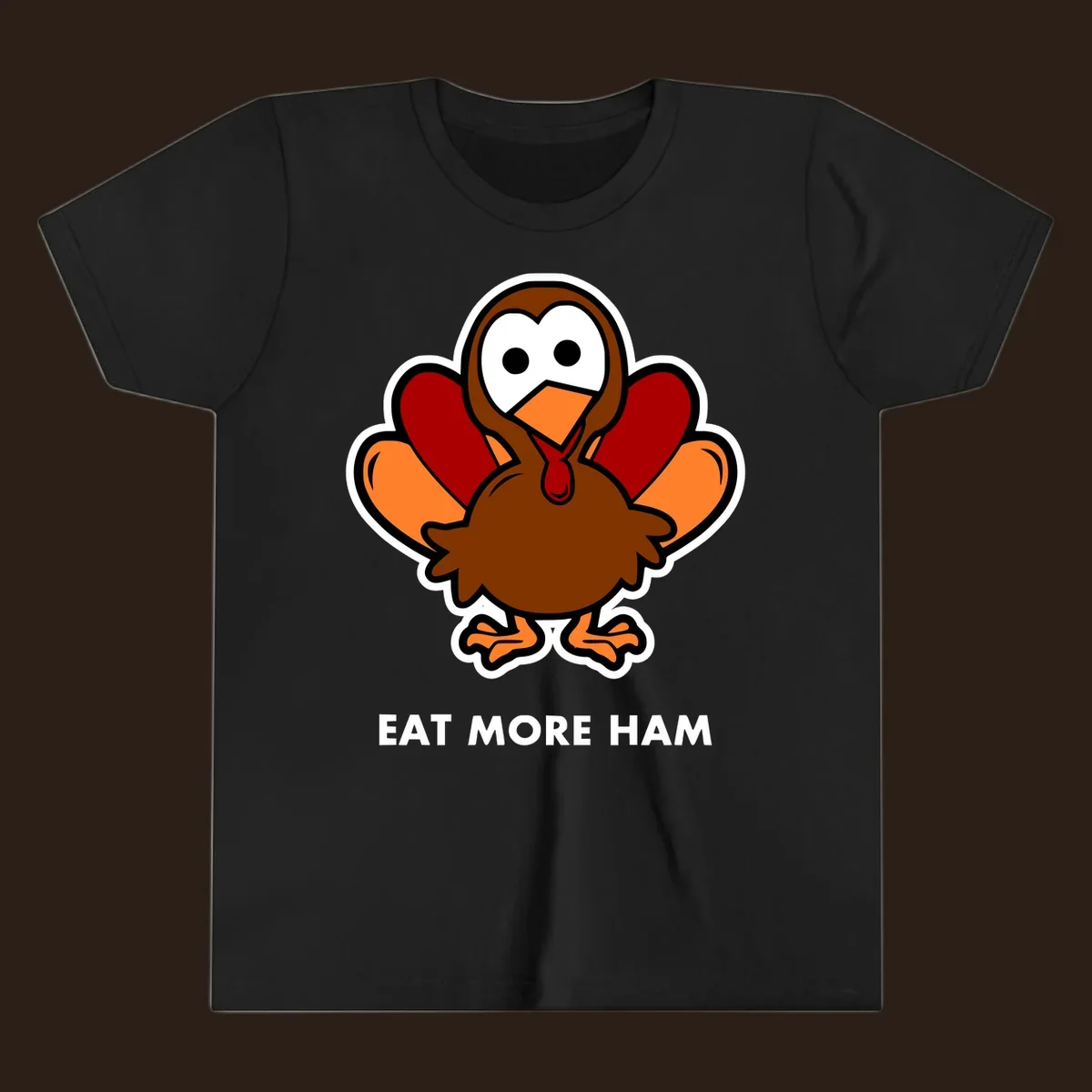 Cartoon turkey with 'Eat More Ham' text, promoting a fun Thanksgiving alternative.