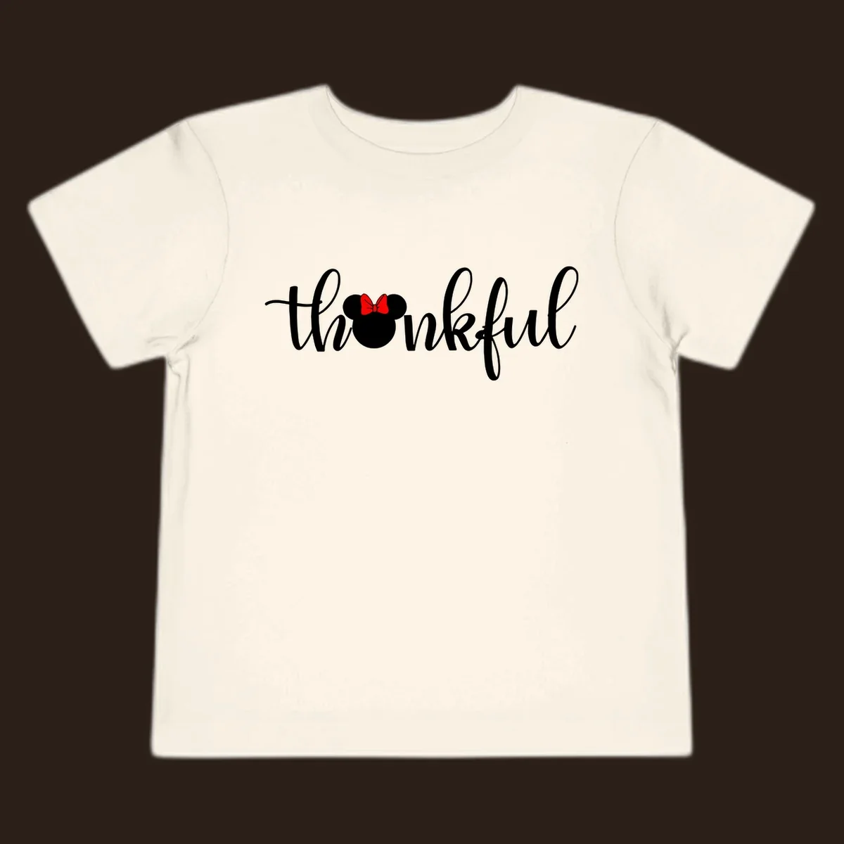 Minnie Mouse silhouette replaces the 'o' in the word 'thankful' in a script font.