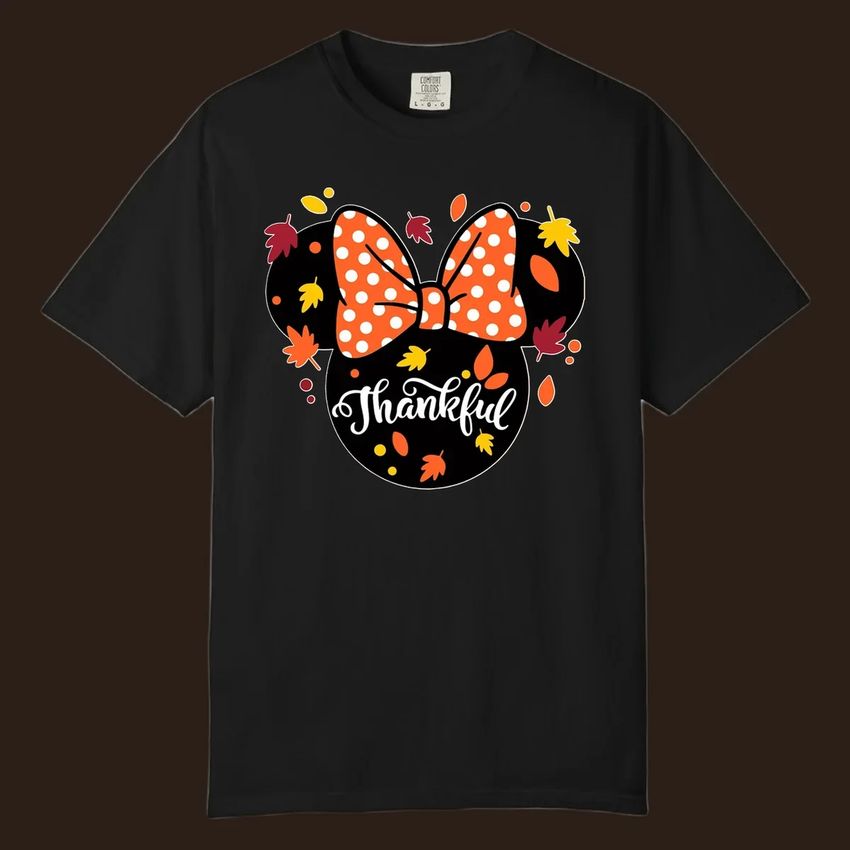 Minnie Mouse silhouette with polka dot bow and fall leaves, text reads Thankful.