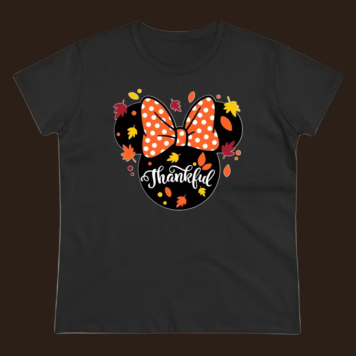 Minnie Mouse silhouette with polka dot bow and fall leaves, text reads Thankful.
