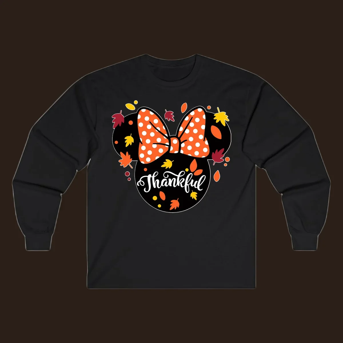 Minnie Mouse silhouette with polka dot bow and fall leaves, text reads Thankful.