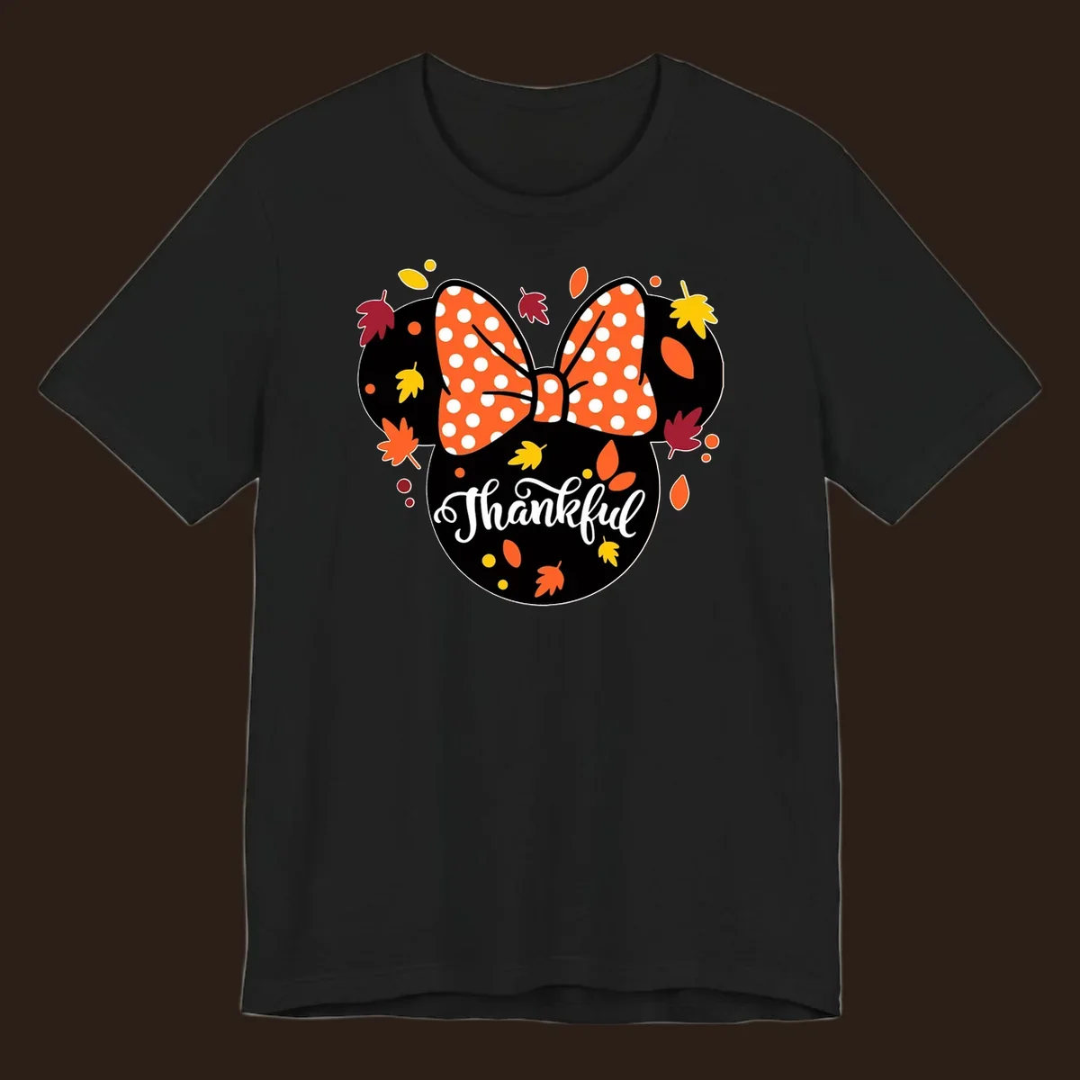 Minnie Mouse silhouette with polka dot bow and fall leaves, text reads Thankful.