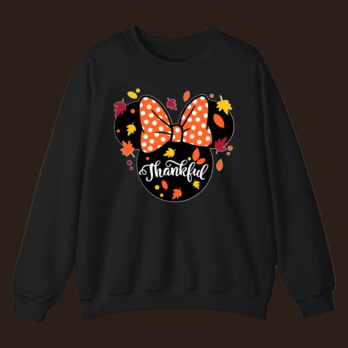 Minnie Mouse silhouette with polka dot bow and fall leaves, text reads Thankful.