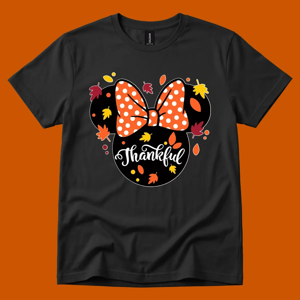 Minnie Mouse silhouette with polka dot bow and fall leaves, text reads Thankful.