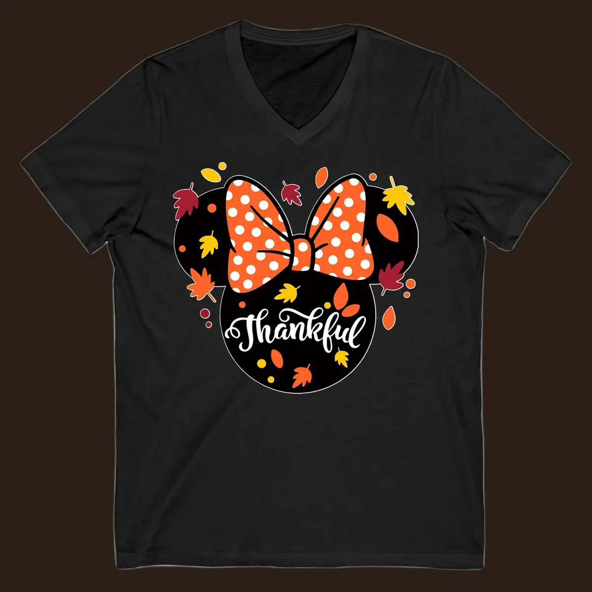 Minnie Mouse silhouette with polka dot bow and fall leaves, text reads Thankful.