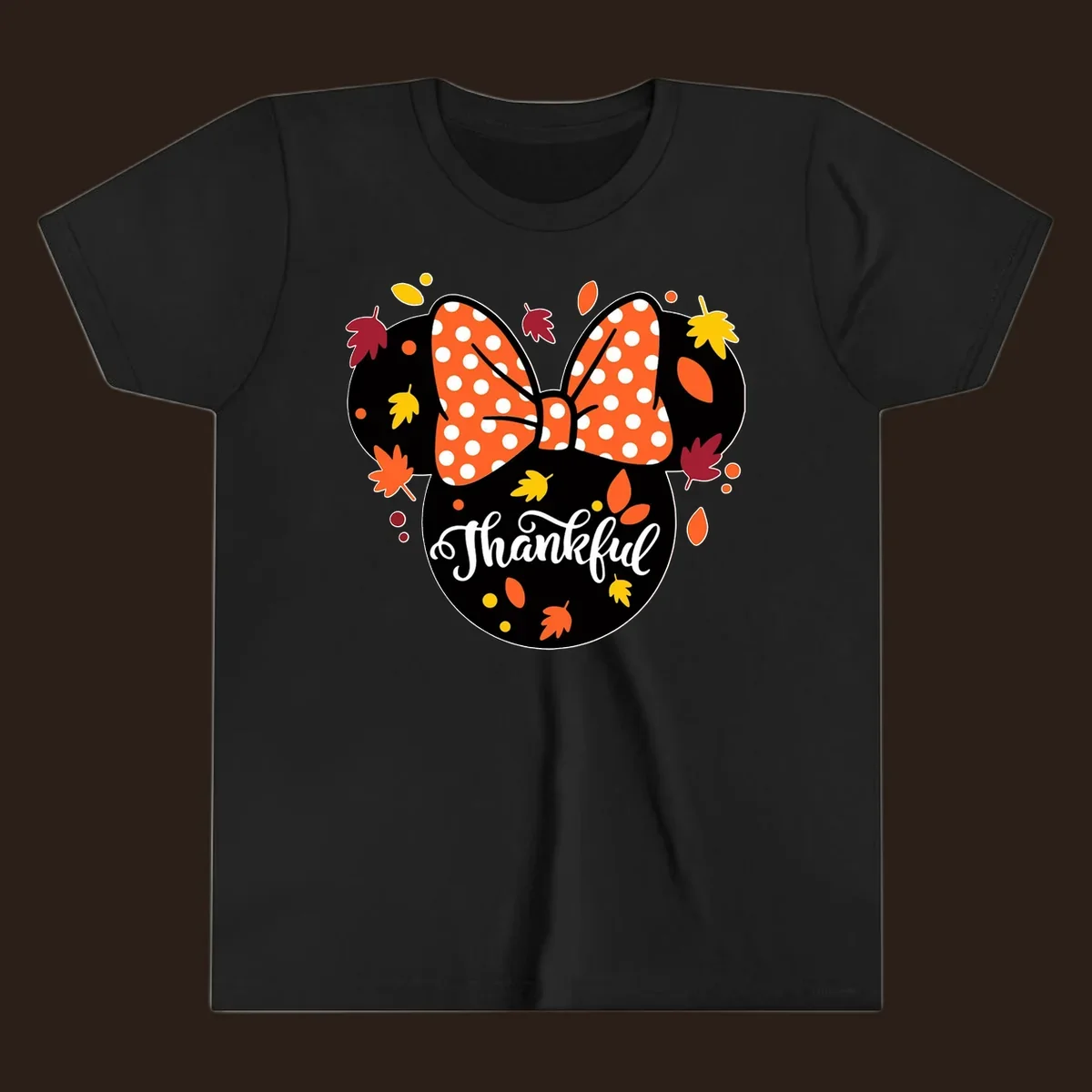 Minnie Mouse silhouette with polka dot bow and fall leaves, text reads Thankful.