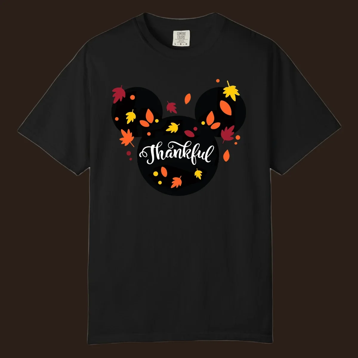 Mickey mouse head silhouette with 'Thankful' text and fall leaves, for thanksgiving shirts.