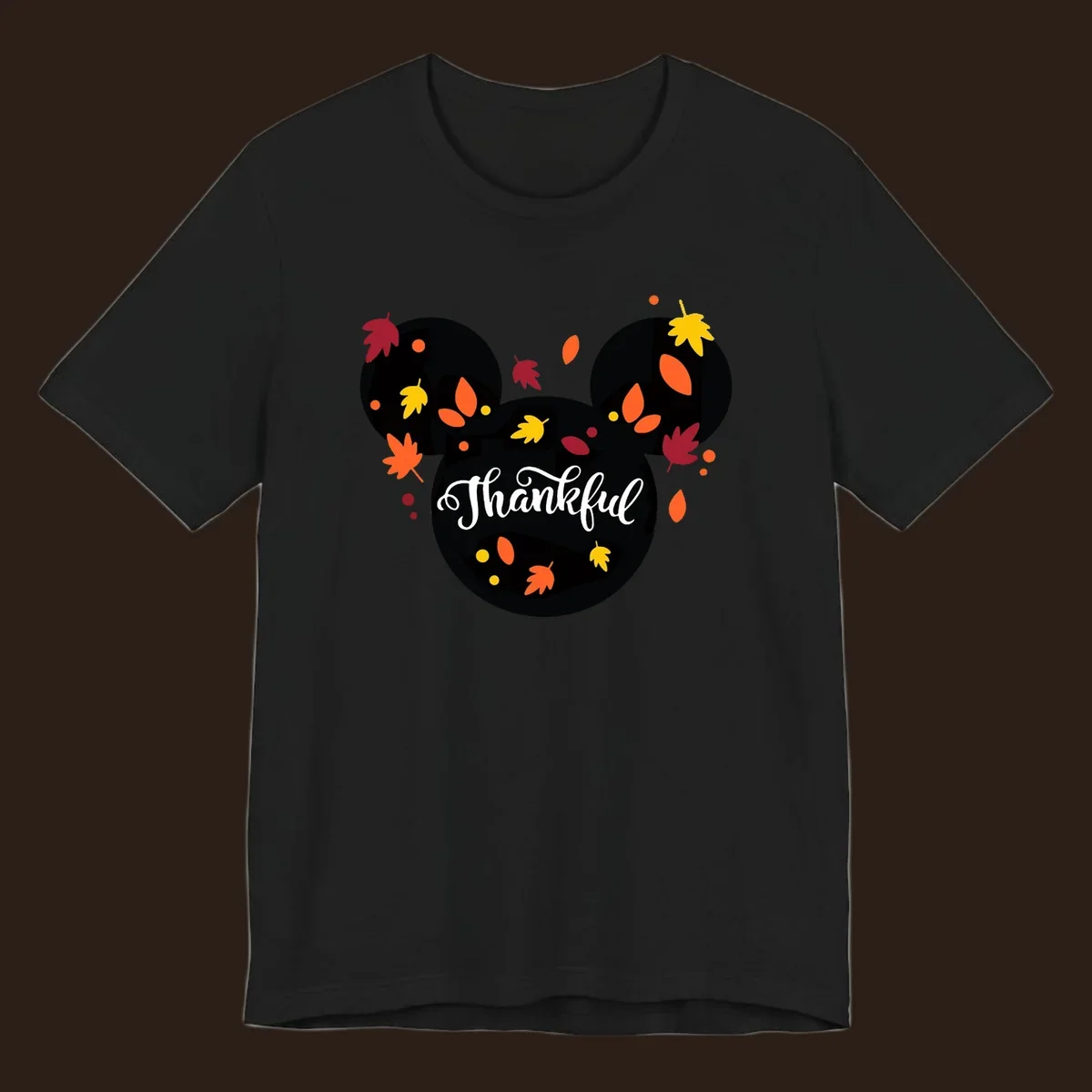 Mickey mouse head silhouette with 'Thankful' text and fall leaves, for thanksgiving shirts.