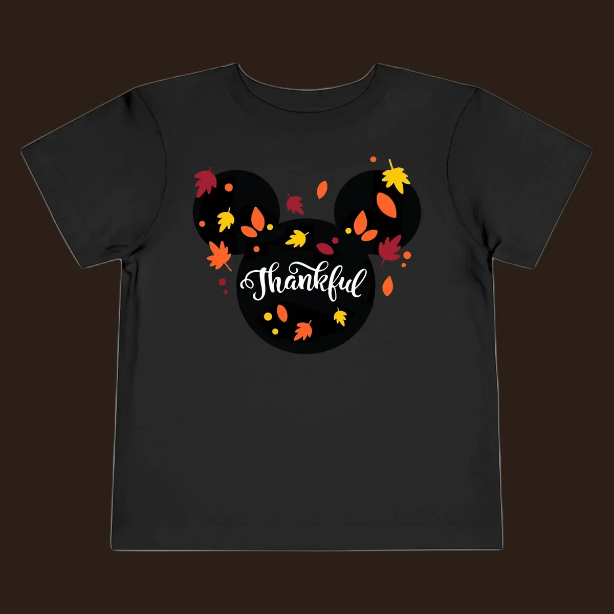 Mickey mouse head silhouette with 'Thankful' text and fall leaves, for thanksgiving shirts.