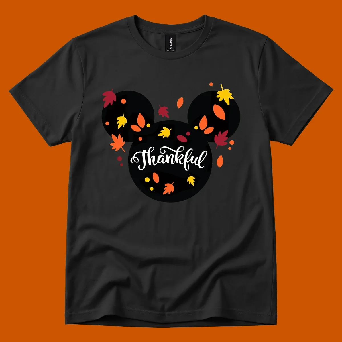 Mickey mouse head silhouette with 'Thankful' text and fall leaves, for thanksgiving shirts.