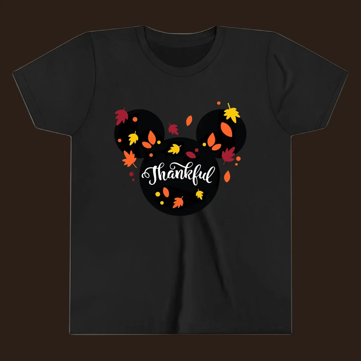Mickey mouse head silhouette with 'Thankful' text and fall leaves, for thanksgiving shirts.