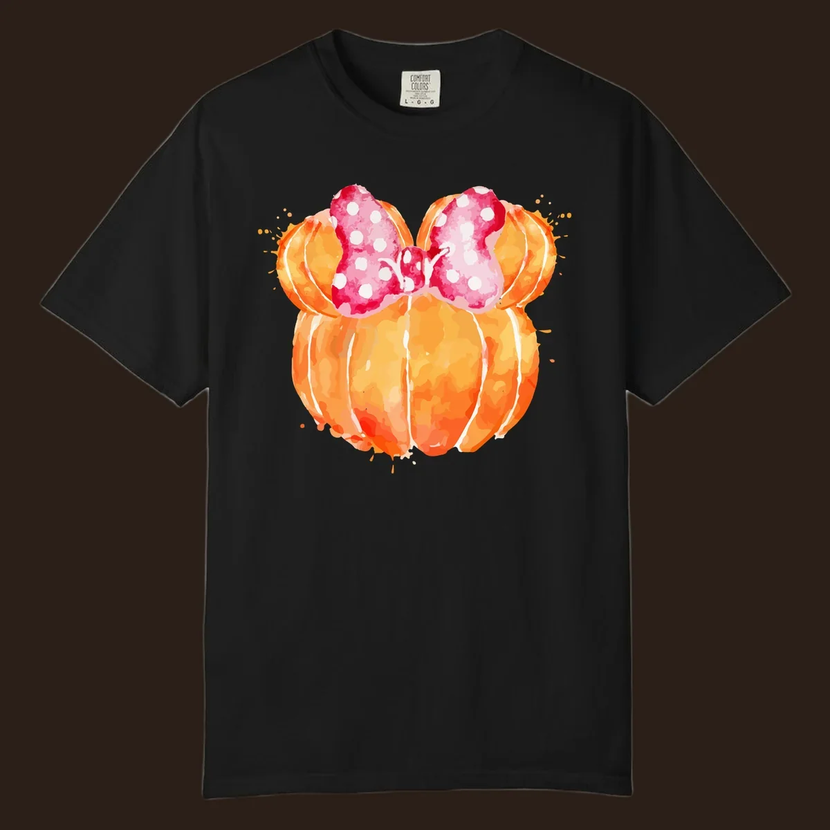 Watercolor illustration of two orange pumpkins shaped like Minnie Mouse ears with a pink polka dot bow.