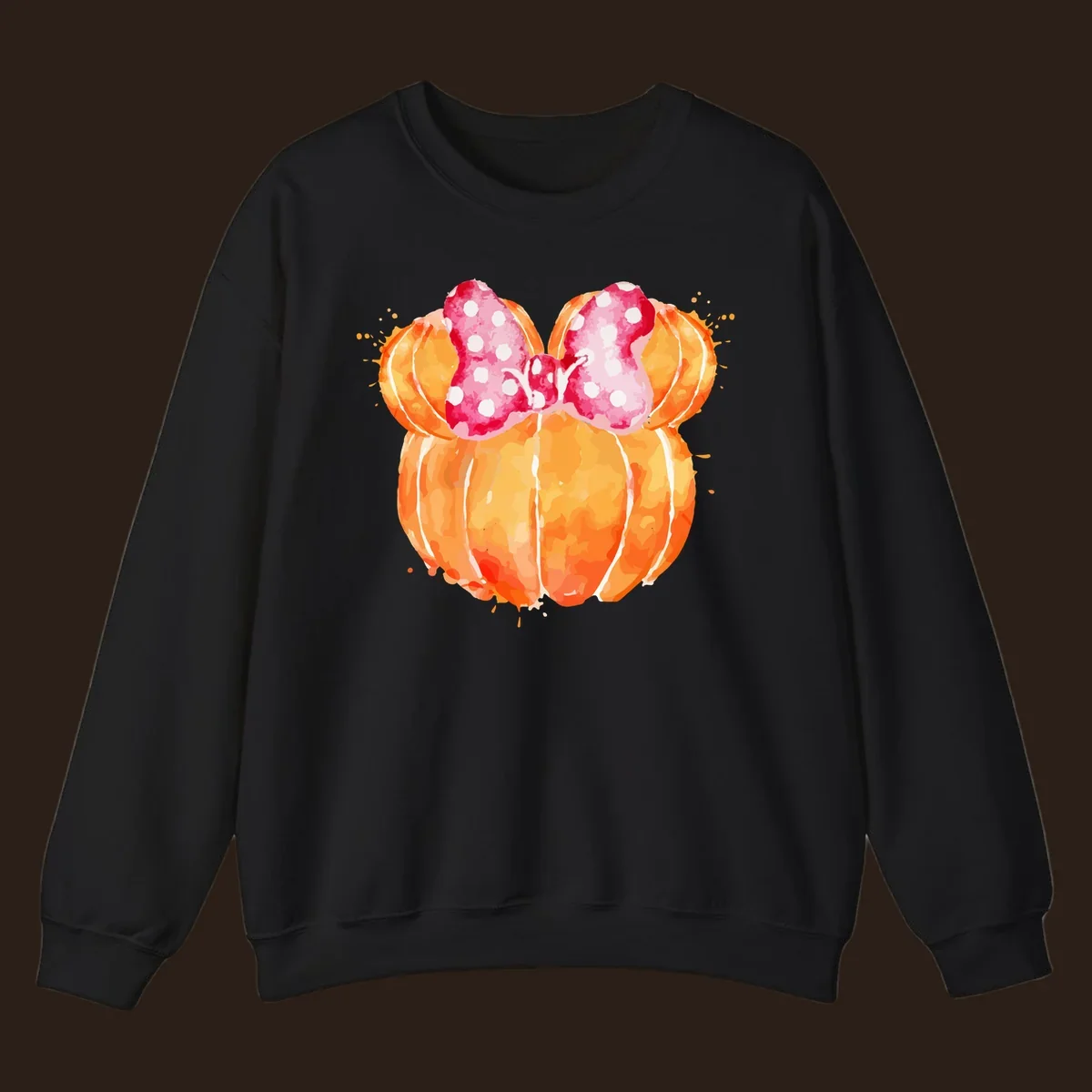 Watercolor illustration of two orange pumpkins shaped like Minnie Mouse ears with a pink polka dot bow.