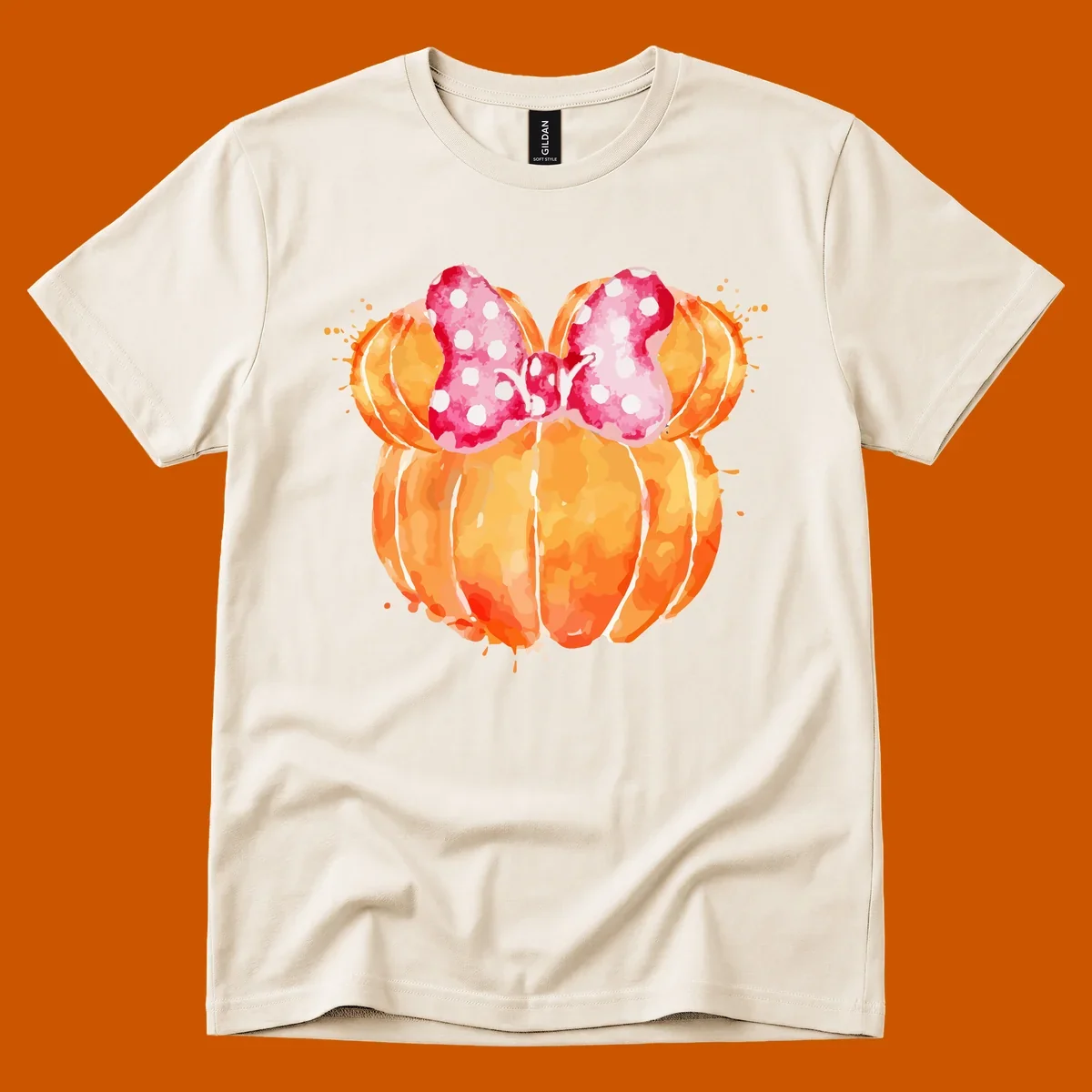 Watercolor illustration of two orange pumpkins shaped like Minnie Mouse ears with a pink polka dot bow.