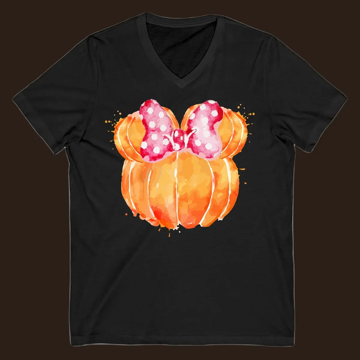 Watercolor illustration of two orange pumpkins shaped like Minnie Mouse ears with a pink polka dot bow.