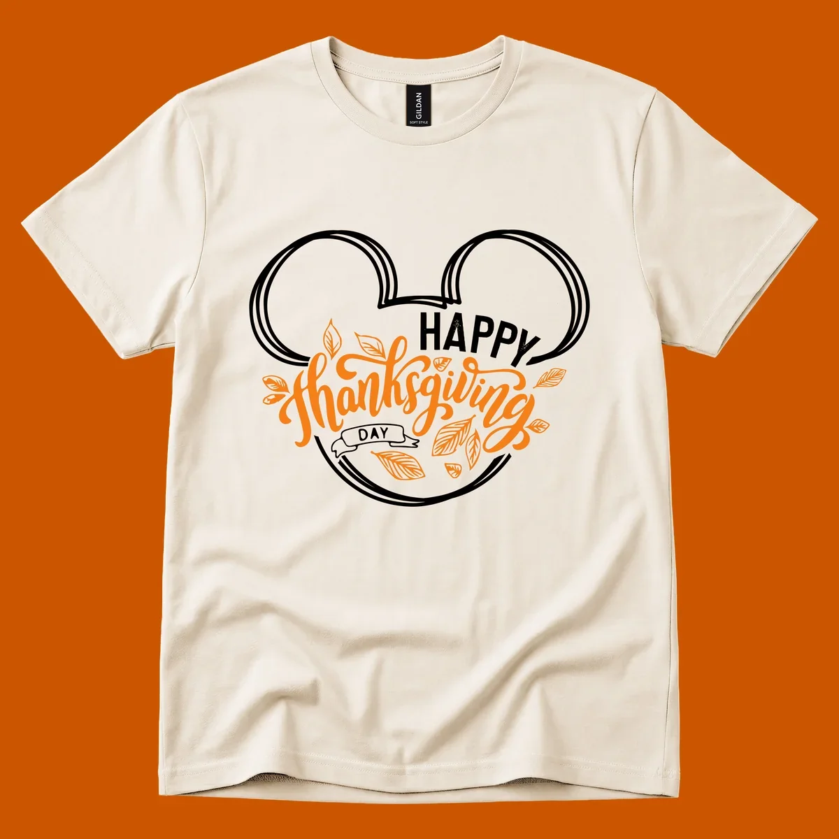 Happy Thanksgiving Day text with Mickey Mouse ears and fall leaves.