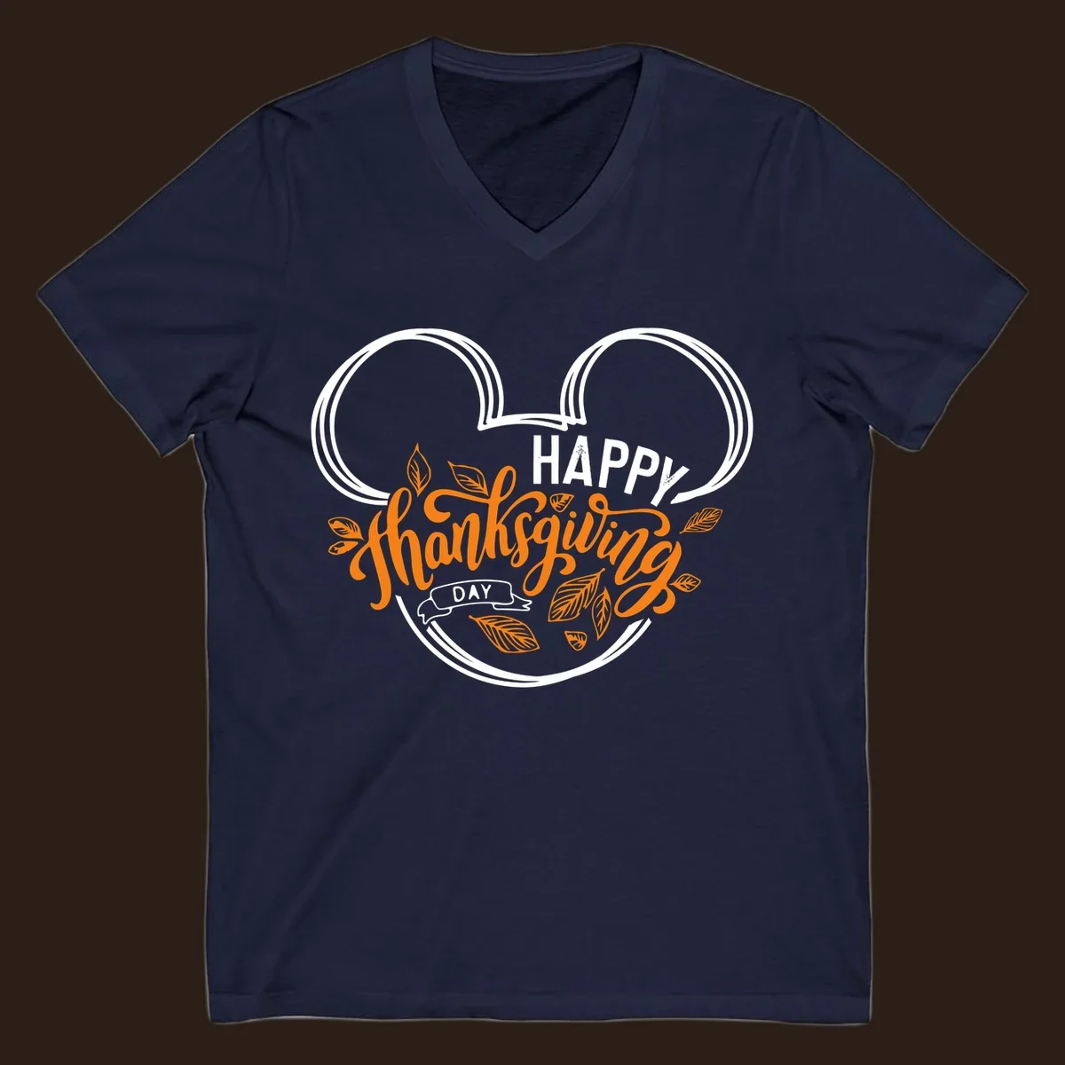 Happy Thanksgiving Day text with Mickey Mouse ears and fall leaves.