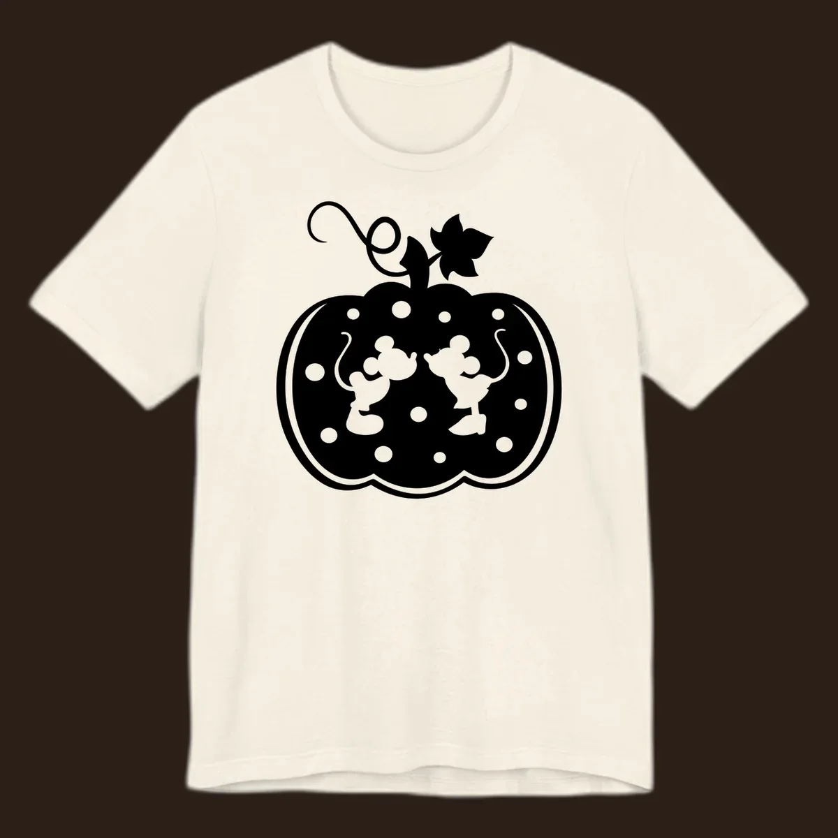 Mickey and Minnie Mouse kissing inside a pumpkin silhouette, with polka dots. Mickey-Minnie-pumpkin.