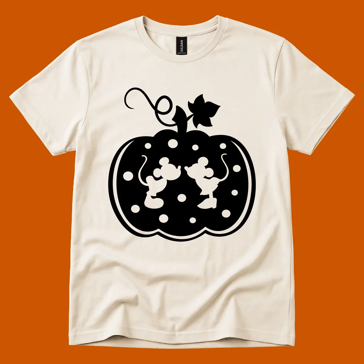 Mickey and Minnie Mouse kissing inside a pumpkin silhouette, with polka dots. Mickey-Minnie-pumpkin.