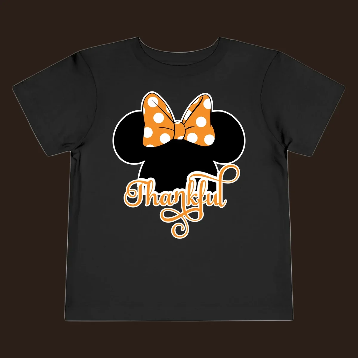 Minnie Mouse ears with orange polka dot bow and "Thankful" text, perfect for Thanksgiving.