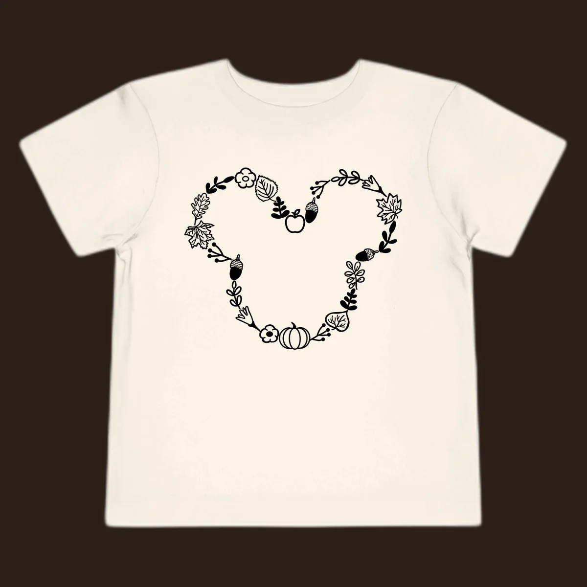 Heart shaped autumn wreath with leaves, acorns, pumpkin, and flowers. Outline design.