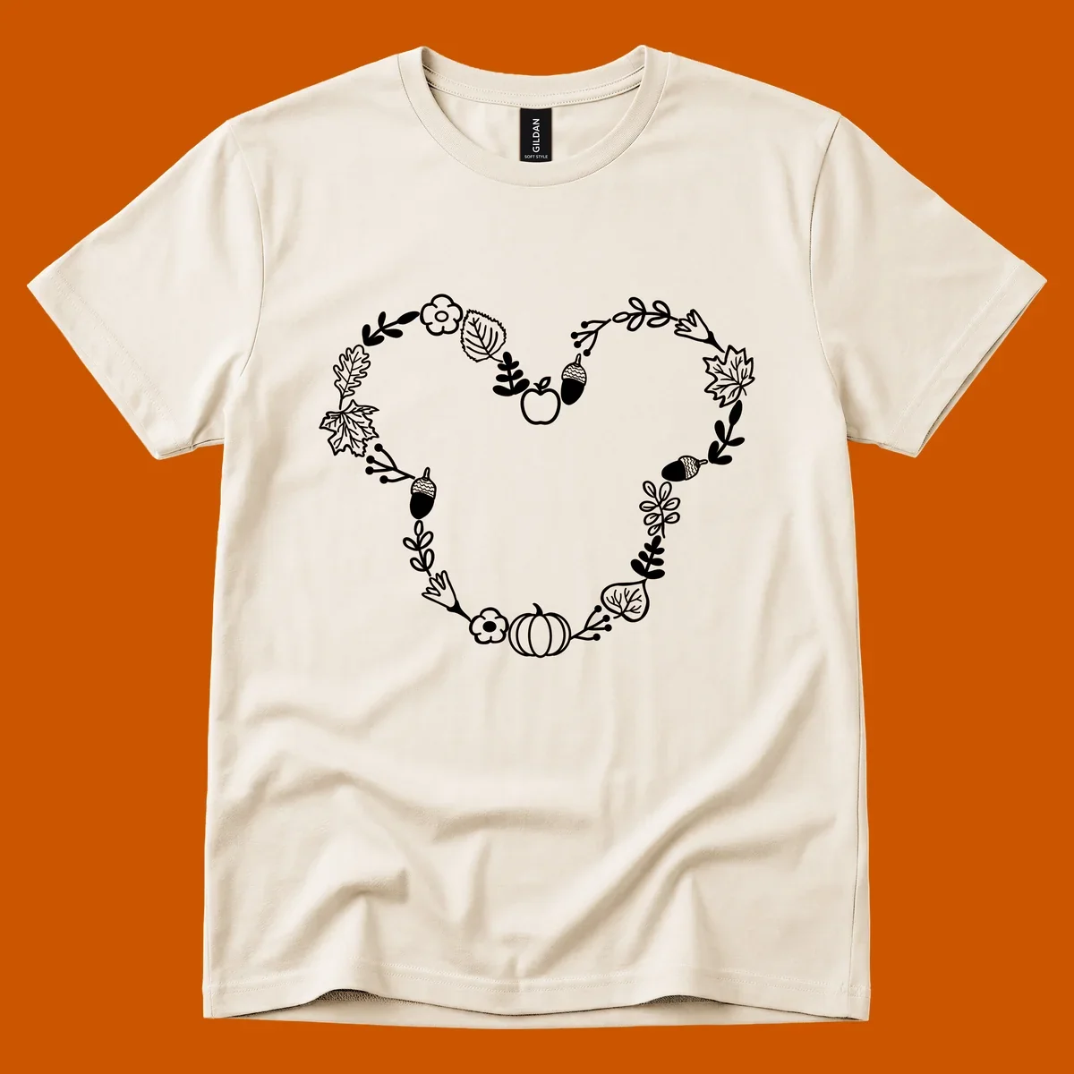 Heart shaped autumn wreath with leaves, acorns, pumpkin, and flowers. Outline design.