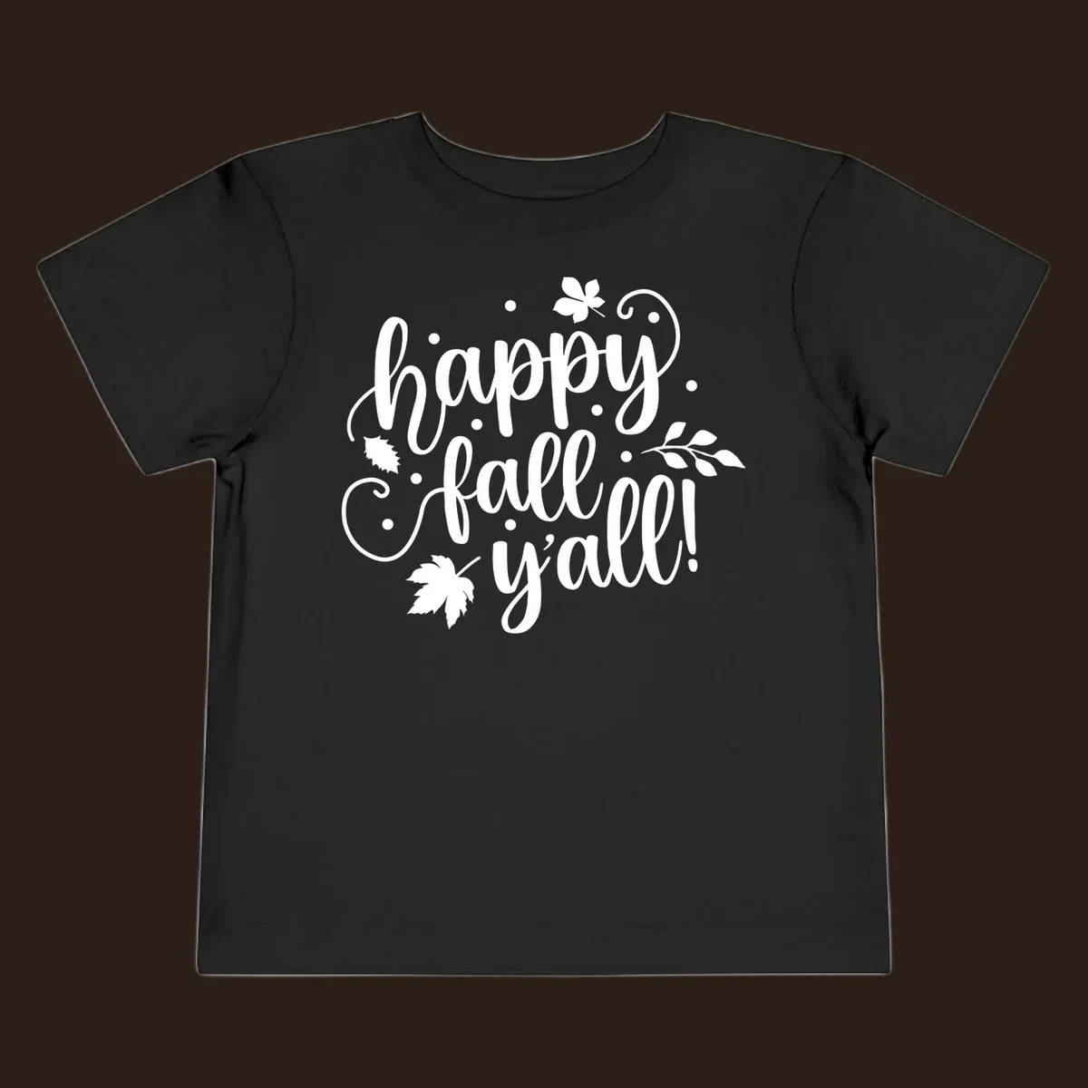 Happy Fall Y'all script design with maple leaves and swirls.